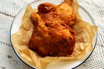 Crispy chicken thighs fried on a wooden table