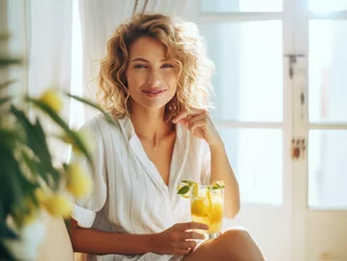 Fototapeten middle age woman drinking orange juice cocktail in the morning  © kora
