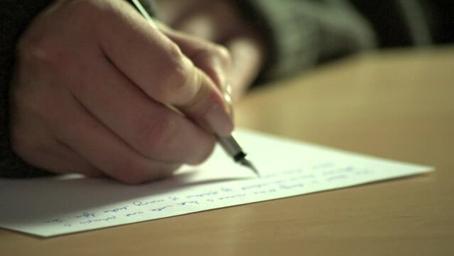 Close-up of fountain pen writing in an old-fashioned paper notebook or diary