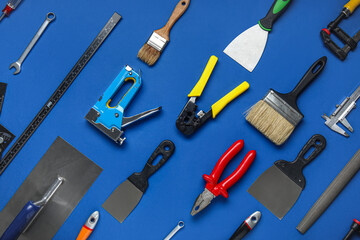 Set of construction tools on blue background