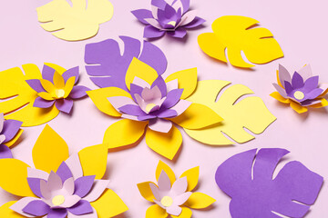 Fototapeta na wymiar Colorful origami flowers and leaves on purple background
