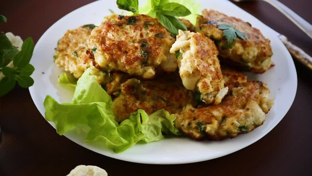 cooked vegetarian fried cauliflower cutlets, in a plate .