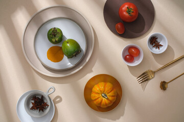 A Thanksgiving table adorned with pumpkins, berries, autumn leaves, and kitchen utensils. Ample copy space for advertising in this exquisite autumn setting.