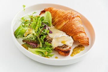 croissant with cheese and salad
