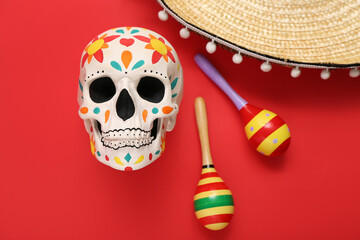 Painted human skull for Mexico's Day of the Dead (El Dia de Muertos) with sombrero and maracas on...
