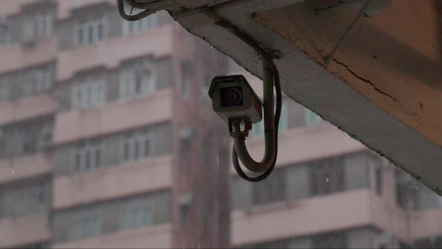 Exterior surveillance on apartment building in heavy rain in slow motion