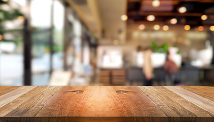 Selected focus empty brown wooden table and Coffee shop blur background with bokeh image. for your...