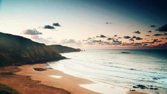 Time lapse of evening clouds moving over sea and Carniciega beach on coast in Asturias. Seascape at sunset in northern Spain.