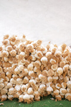 vertical shot of stack of garlic selling at market with copy space 