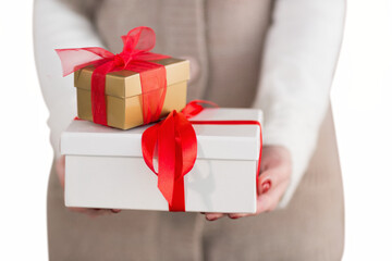 Digital png photo of hands of caucasian woman holding presents on transparent background