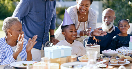 Black family, birthday party and clapping for a boy child outdoor in the yard for a celebration event. Kids, applause and milestone with a group of people in the garden or backyard together in summer - obrazy, fototapety, plakaty