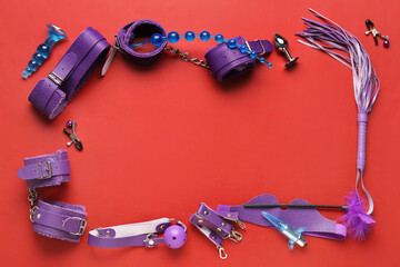 Frame made of different sex toys on red background