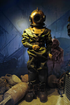 Large deep-sea diving suit with helmet and boots on a full-length mannequin. On display at the Naval Museum: Istanbul, Turkey - October 22, 2023.