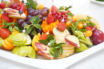 Fresh fruits and berries stacked on a plate