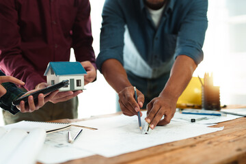 Architect or engineer are designing house, modifying plan, creating construction project and addition according to customer requirement.