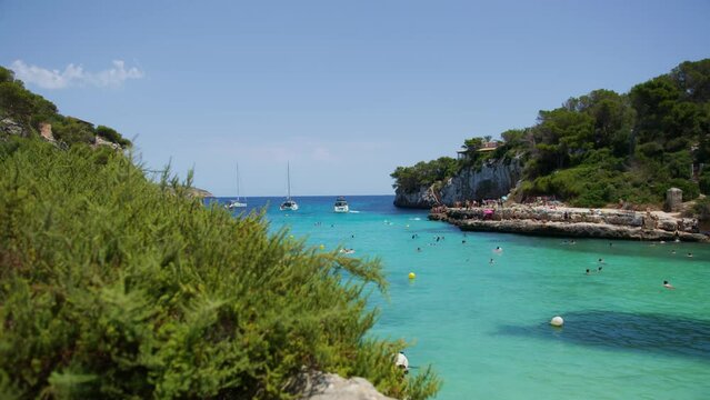Mallorca: Beach Side View Of Resort In Cala Liombards On Majorca Island, Spain, Europe | Hillside View of Beachgoers