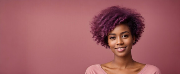 A portrait of a young beautiful  African American woman with an afro hair style and pink t-shirt, smiling poses against a pink background. minimalistic style banner with copy space for text.