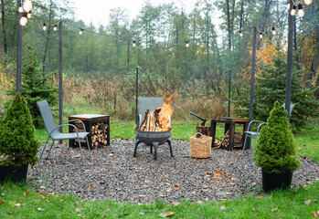 Fire pit and burning fire in a garden