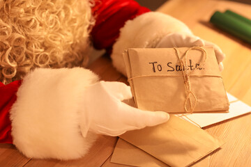 Santa Claus with letters at table