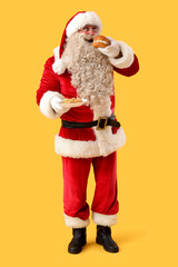 Santa Claus with tasty falafel balls and burger on yellow background
