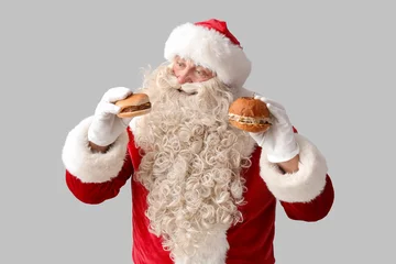Fotobehang Santa Claus with tasty burgers on white background © Pixel-Shot
