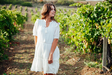 woman in white dress in vineyard walk