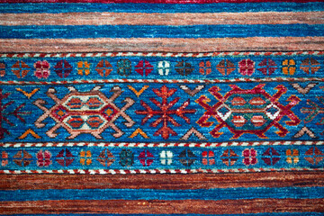 Pattern of traditional Turkish carpet. Multicolor fragment, blue and red ornament. Kushadasi, Turkey (Turkiye)