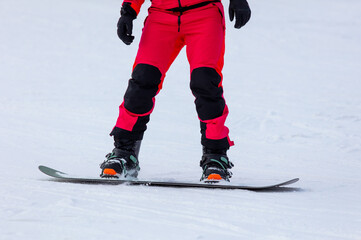 A man snowboards in the snow in winter