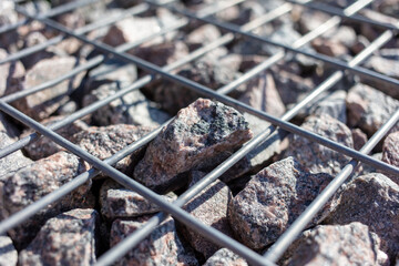 Stones under a metal grate. Background