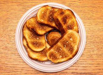 Bread fried in a toaster on a wooden table