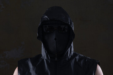 unknown man in a black mask in a hood