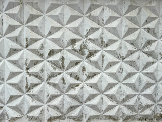 Fototapeta premium Patterned white concrete fence as background. Texture