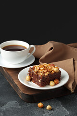 Brownie cake with chocolate and hazelnuts on plate