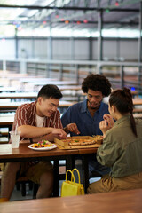 Friends enjoying delicious pizza in outdoor cafe