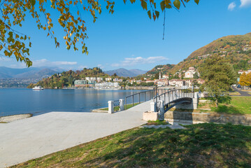 Lake Maggiore on a beautiful sunny day and the town of Laveno, Italy. In the distance you can see a...