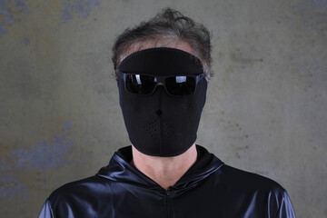 unknown man in a black mask on a black background
