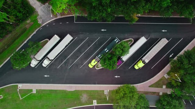 top down cinematic aerial semi truck rest area in Florida with highway, Transportation concept.