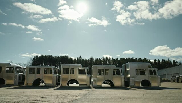 6 unfinished fire trucks under sunny sky. Fire department vehicles cabin
