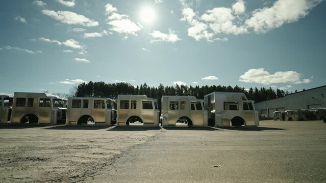 Array of unfinished fire trucks under the bright sun,industrial assembly and emergency vehicle production. Marion, Wisconsin, real time