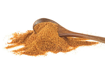 Coconut palm sugar pile in wooden spoon isolated on a white background