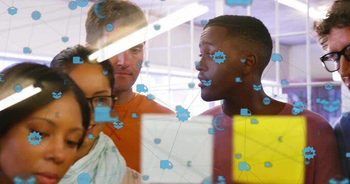 Animation of connected icons over diverse coworkers discussing strategy on sticky notes