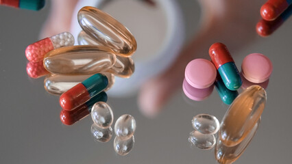 Various Medicine Pills, Tablets and Vitamins on Glass Table. Healthcare concept