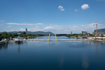 Fototapeta na wymiar Vienna, Austria - July 5, 2023: pedestrian bridge across river Danube