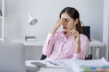 Tired exhausted or sad business young asian woman sleepy and bored from sitting at a desk.tired of working in a laptop,