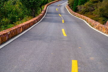 Blue sky down the hill in the asphalt road