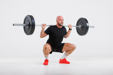 Fototapeta na wymiar Portrait isolated cutout full body studio shot strong Caucasian male fitness athlete sporstman trainer model in casual sport workout outfit posing lifting barbell training on white background.