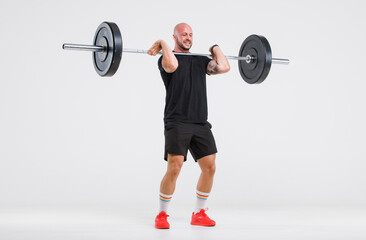 Portrait isolated cutout full body studio shot strong Caucasian male fitness athlete sporstman trainer model in casual sport workout outfit posing lifting barbell training on white background.