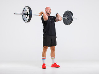 Portrait isolated cutout full body studio shot strong Caucasian male fitness athlete sporstman trainer model in casual sport workout outfit posing lifting barbell training on white background.