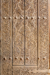 Carved wooden door decoration. Floral design pattern. Close up fragment. Khiva (Xiva), Uzbekistan