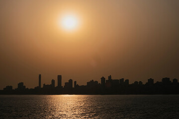 Mumbai downtown sunset cityscape India. City in the setting sun. A bright colourful sunset sky over the black silhouettes cityscape.